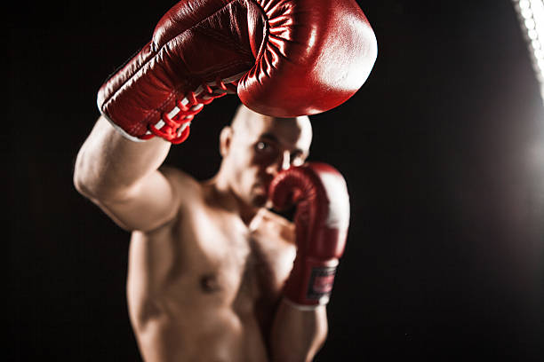 istock The young man kickboxing on black 516934178
