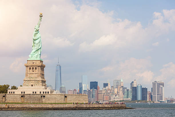 istock Statue of Liberty with Downtown Skyscrapers on Background 516942809