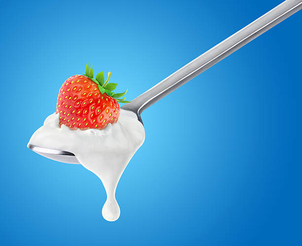 istock Spoon of yogurt with strawberry on top 516942927
