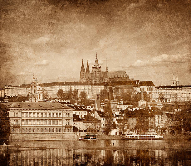 View of Charles bridge over Vltava river and Gradchany  and St. Vitus Cathedral vintage sepia toned  with grunge texture overlaid