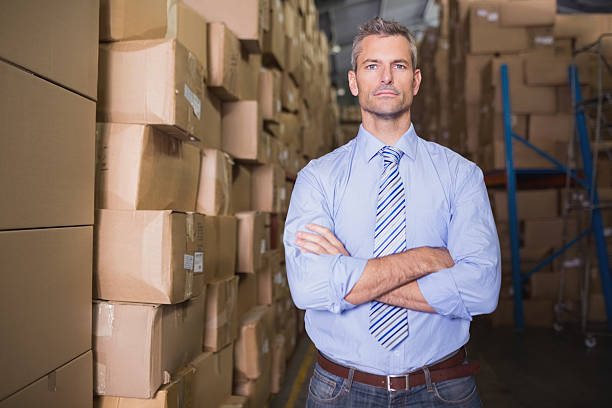 istock Serious manager with arms crossed in warehouse 516945197