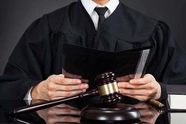 istock Judge Holding File With Mallet On Desk 516945229