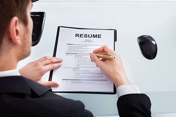 istock Businessman Analyzing Resume At Office Desk 516945303