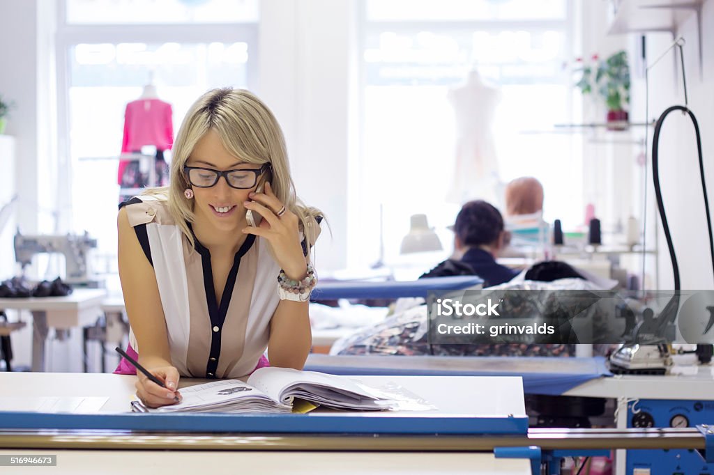 Young woman starting new business Young self employed woman taking customer orders by phone. Small Business Stock Photo