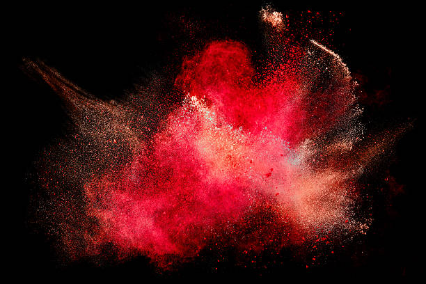 Colorful Dust Particle Explosion Isolated on Black Colorful dust particle explosion resembling blood or a pyrotechnic effect over black. Closeup of a color explosion isolated on black powder snow stock pictures, royalty-free photos & images