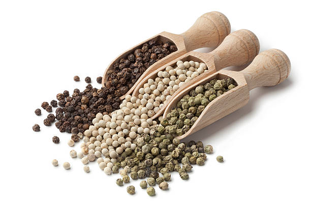istock Wooden scoops with black, white and green peppercorns 516947480