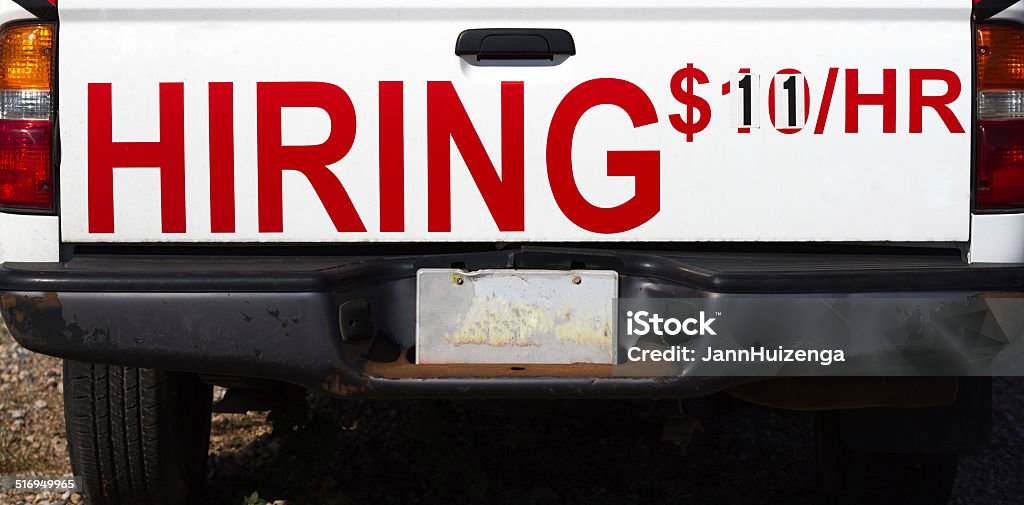 "HIRING" Sign on Back of Pickup Truck ($11/HR) A red "HIRING" sign on the back of a pickup truck ($11/HR). A bit of copy space available on the black portion at the bottom of the frame. Advertisement Stock Photo