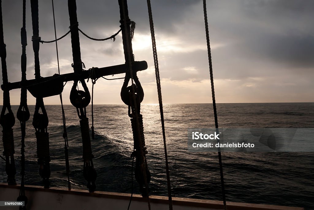 Navigation gear Ancient navigation gears against sunrise seascape Ghost Ship Stock Photo