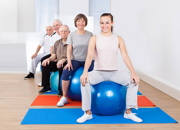 istock People Sitting On Fitness Balls In Exercise Class 516950733