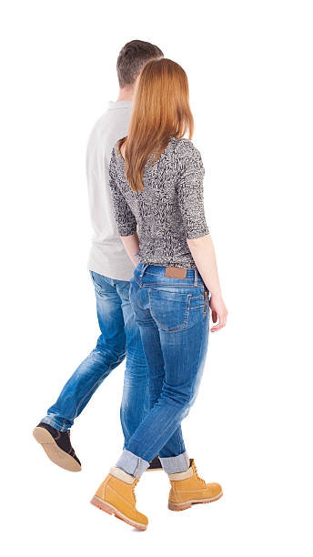 istock Back view going couple. walking friendly girl and guy holding 516950774