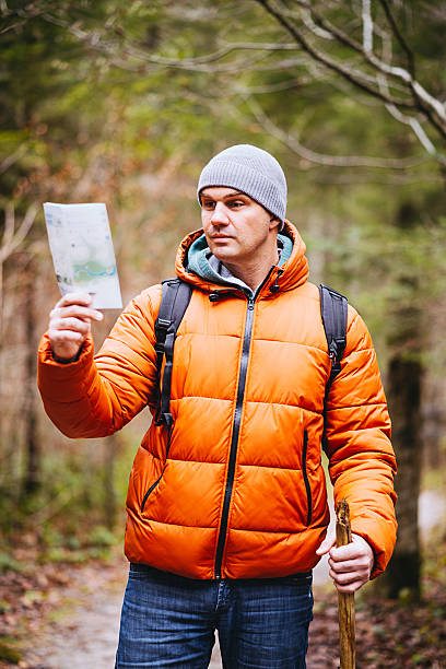 istock Explorer hiking in national park and finding directions near river 516951326