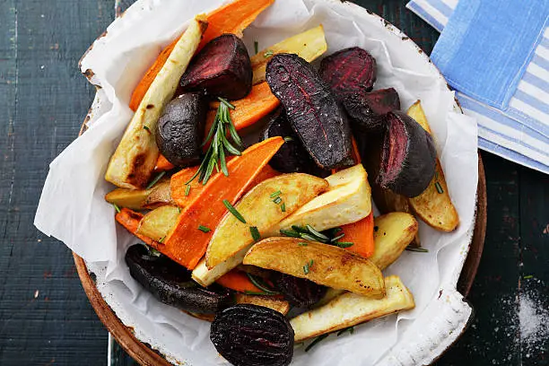 baked carrots and beets with herbs, food top view