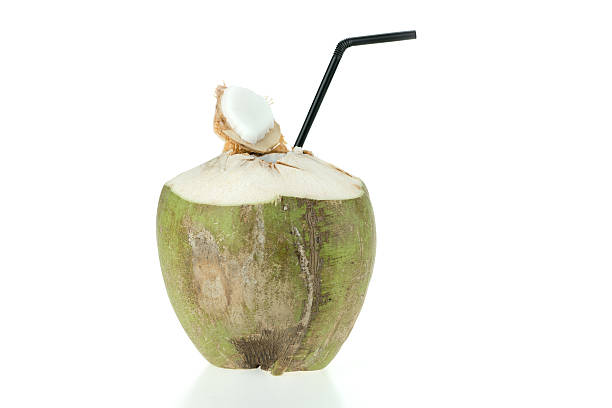istock Opened green coconut with straw, isolated on white background 516952884
