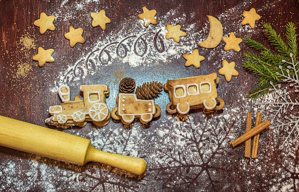 Gingerbread train shaped cookies, rilling-pin and stars. Christmas cooking/
