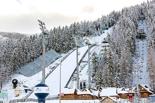 Calgary, Alberta, Canada, March 18, 2021: Olympic ski jumping venue set up, ski lift and a snowmaking machine at the Olympic Park.
