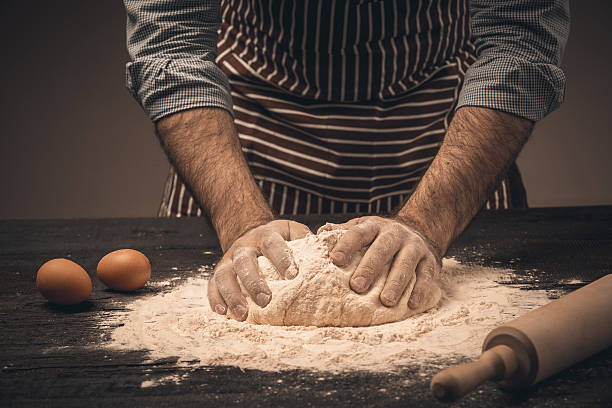 istock Male hands knead the dough. 516955192