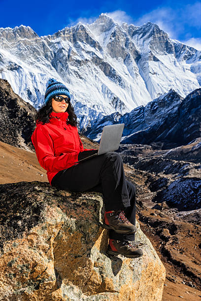 istock Young woman using laptop in Himalayas, Nepal 516956116