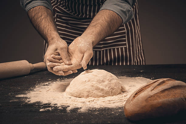 istock Male hands knead the dough. 516956166