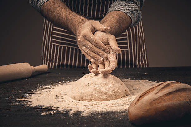 istock Male hands knead the dough. 516956248
