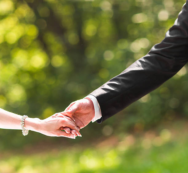 istock Happy couple holding hands outdoors 516956964