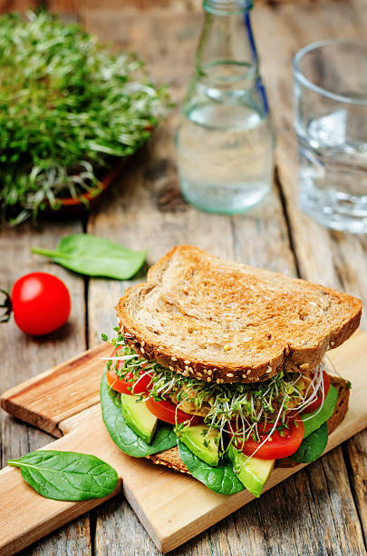 istock sprouts avocado tomato spinach chickpeas burger rye sandwich 516957542