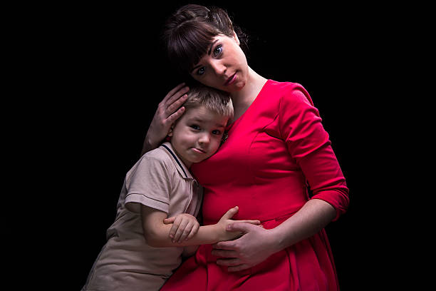 istock Gentle pregnant mother and little son 516959200