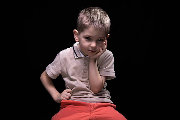 istock Little bored boy with hands on hips 516960530