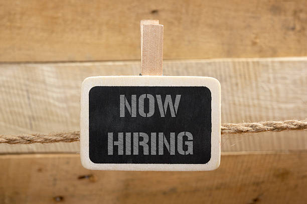 istock Now hiring handwritten with white chalk on a blackboard at 516961108
