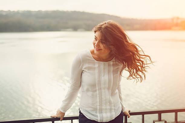 istock Young plus size woman near a lake 516979350