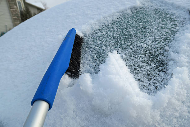 istock Cleaning snow and heavy  ice from car window 516979556