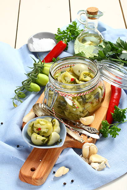 istock glass jar with pickled green tomatoes prepared for winter 516980237