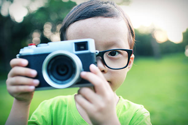 istock cute child plays the photographer 516980245
