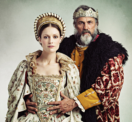 Studio portrait of a stern-looking king and queen