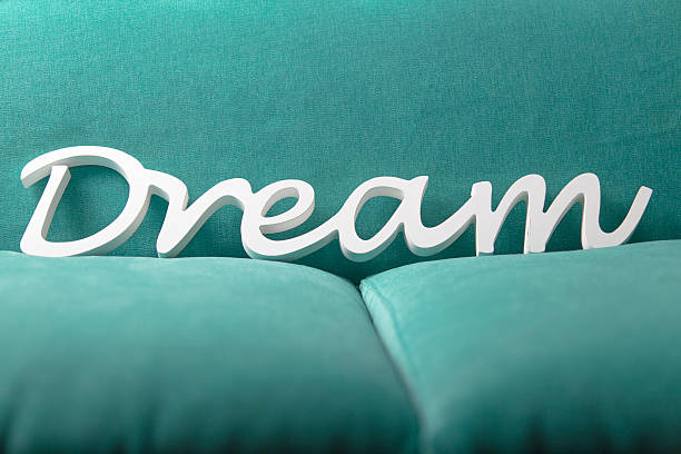 White Dream letters on a bright blue sofa