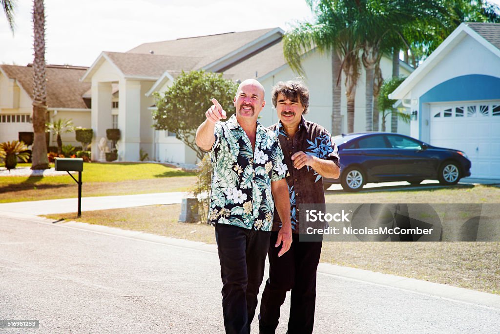 Mature Gay couple looking for suburban home Mature Gay couple looking for suburban home somewhere in Florida. One of them is pointing at a possible house. They could also be criticizing neighbors. Gay Person Stock Photo