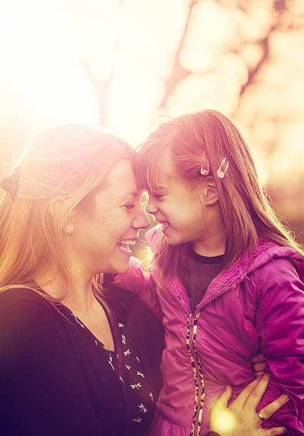 istock Mother and daughter smiling together at sunset 516981332
