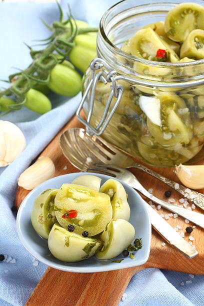 istock Pickled green tomatoes in blue bowl 516981637