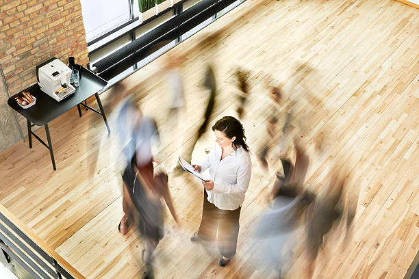 istock Busy business people moving around one person 516982107