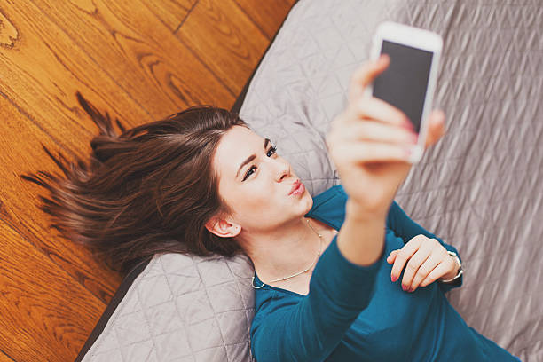 istock Young woman with a cell phone at home 516982136