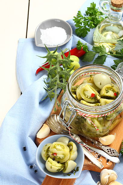 istock glass jar with pickled green tomatoes prepared for winter 516982359