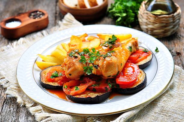 istock Braised chicken in white wine with eggplant, tomato 516982404
