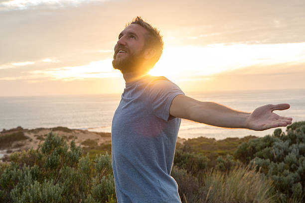 hombre joven disfrutando de la vida - aspirations men human arm arms outstretched fotografías e imágenes de stock