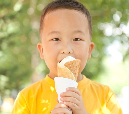 Asian boy 6 years eating ice cream in summer