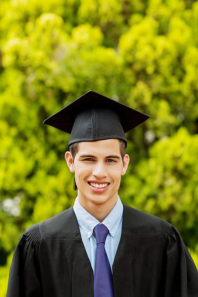 istock Graduate Student Wearing Gown And Mortar Board On Campus 516983389