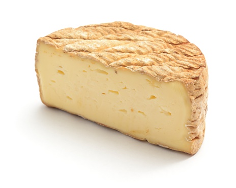 Tomme de Savoie cheese isolated on a white background.