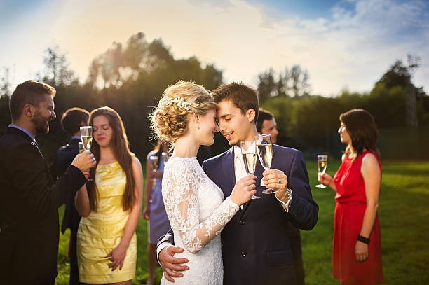 istock Newlyweds clinking glasses outside 516984531