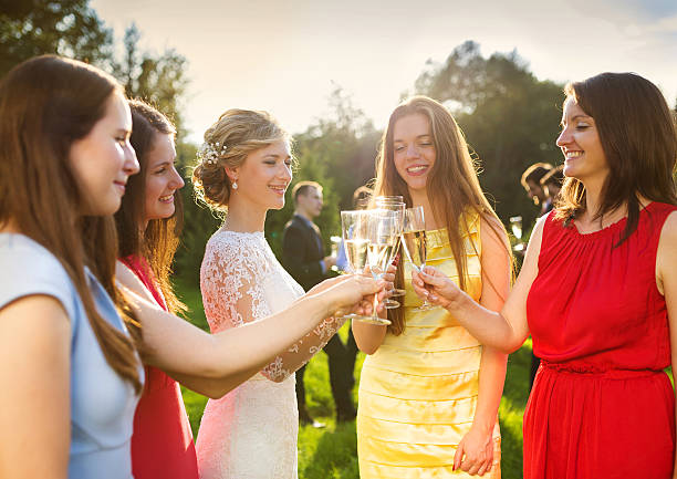 Bride with bridesmaids toasting Bride with four happy bridesmaids toasting at the wedding reception outside guest stock pictures, royalty-free photos & images