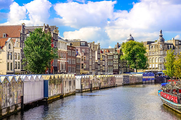 Scenic view of canal in Amsterdam at flower market Scenic view of canal in Amsterdam at flower market, Netherlands flower market stock pictures, royalty-free photos & images