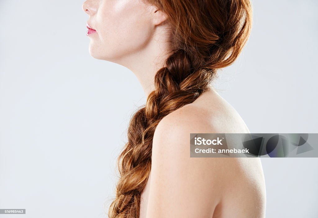 Flawless beauty Cropped side view of a young woman with braided hair standing against a gray background Braided Hair Stock Photo