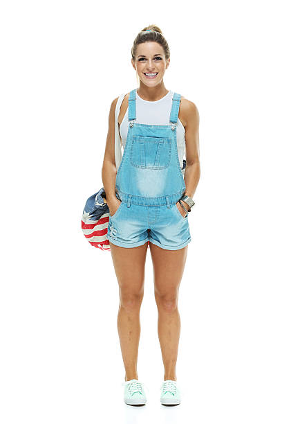 istock Cheerful woman standing with hands in pockets 516985537